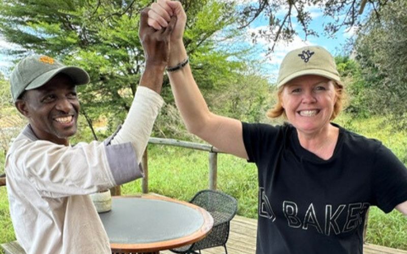 Marula Hill Travel co-owner Vikki Jackson sharing a celebratory moment with Solly, the butler, during a safari stay in South Africa