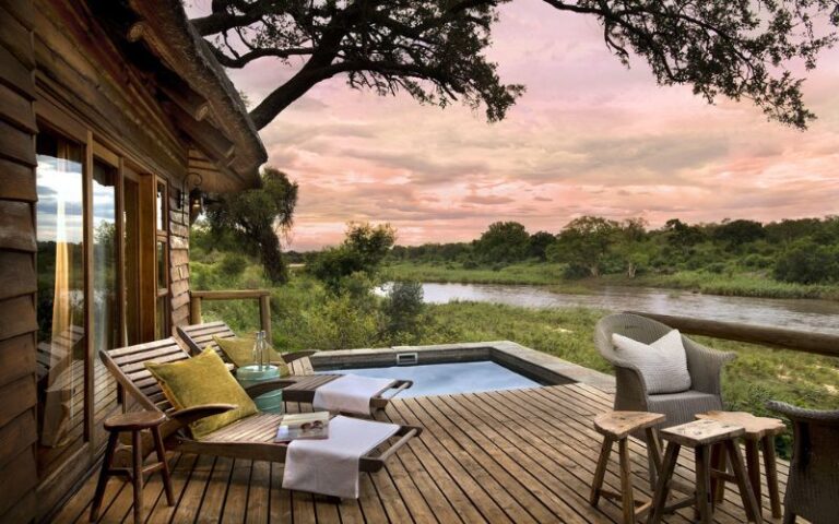 A romantic safari lodge in South Africa with a private deck overlooking the savanna, perfect for a honeymoon retreat