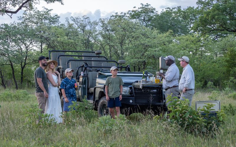 Family enjoying a guided safari sundowner in the Kruger National Park, showing how structured experiences make the Kruger National Park safe for kids.