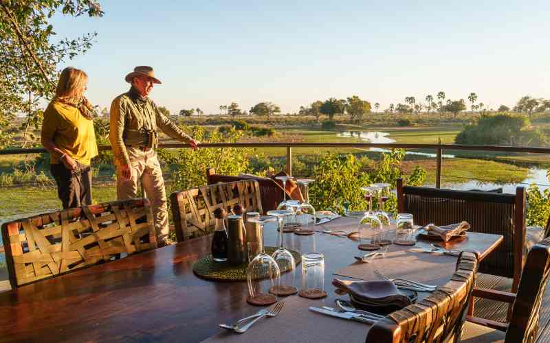 Guests enjoying a scenic deck overlooking wildlife and wetlands during an African safari lodge experience arranged by Marula Hill Travel.