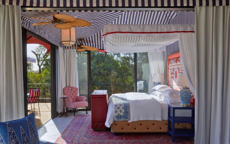 Luxury tented bedroom at Royal Malewane Masiya’s Camp with elegant décor, outdoor views, and refined safari styling
