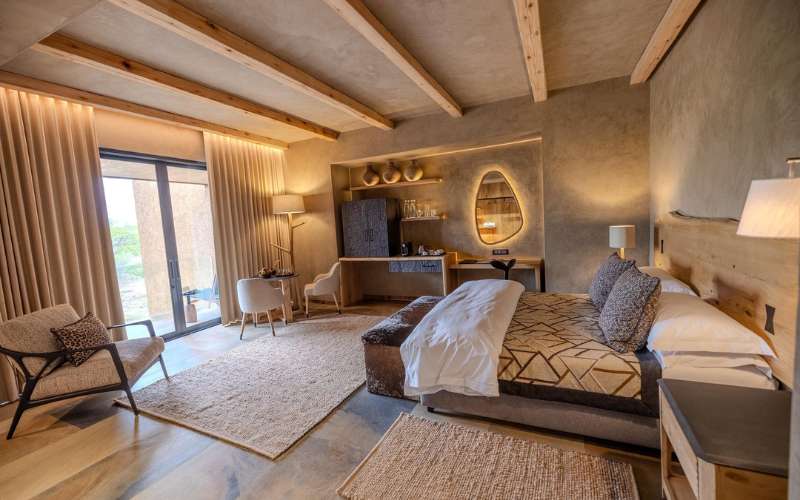 Interior of a Tamboti Suite at Kapama River Lodge showing luxury safari bedroom and lounge area